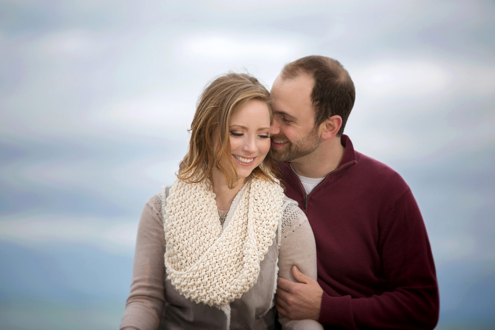 Engagement photo of a happy couple by Astrapia Photography