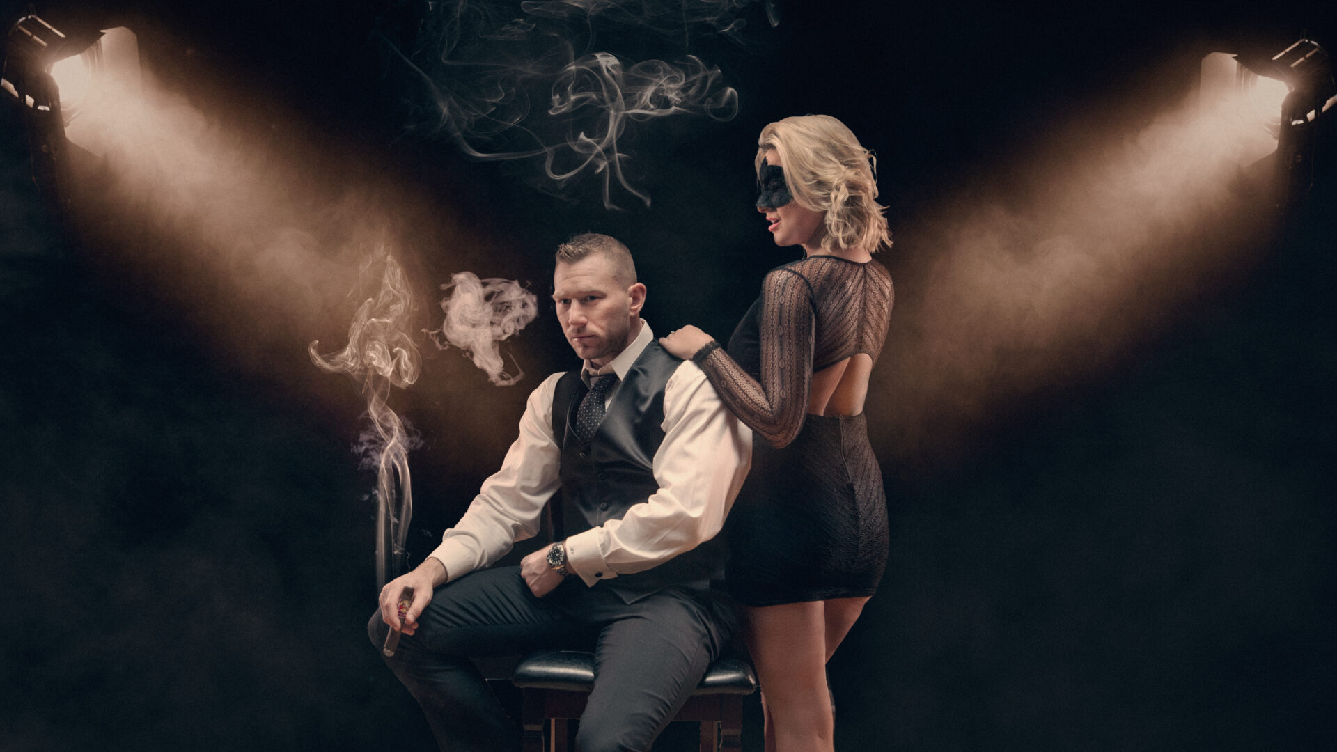 Portrait photo of a blonde woman and a man sitting in a chair by Astrapia Photography