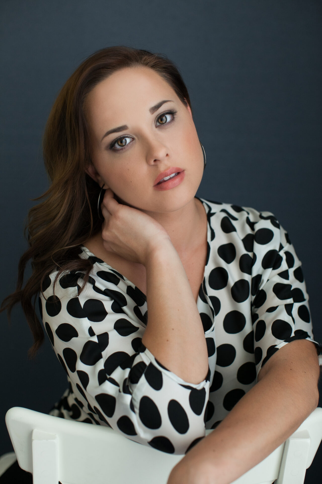 Portrait photo of a woman wearing black and white polka dots by Astrapia Photography